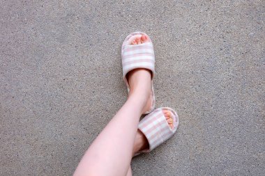 Damalı terlik, yakın çekim Womans pembe ev terlik ayak ve bacaklar arka plan