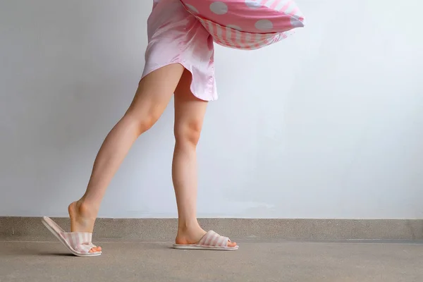 Girl Standing in Sleepwear and Pink Checkered Slippers with Holding Pink Pillow on Floor