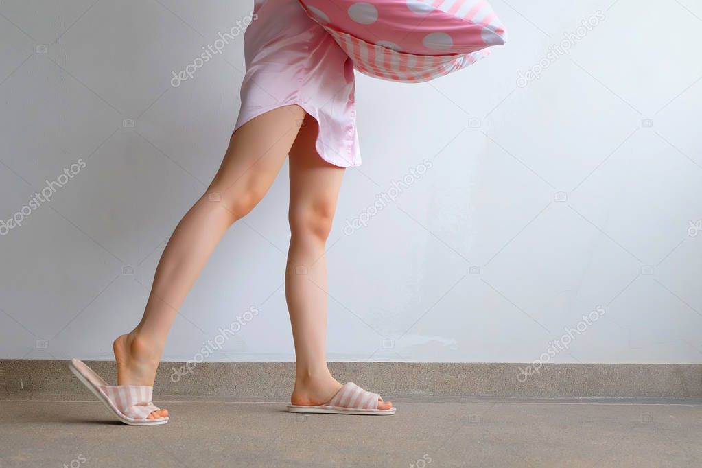 Girl Standing in Sleepwear and Pink Checkered Slippers with Holding Pink Pillow on Floor