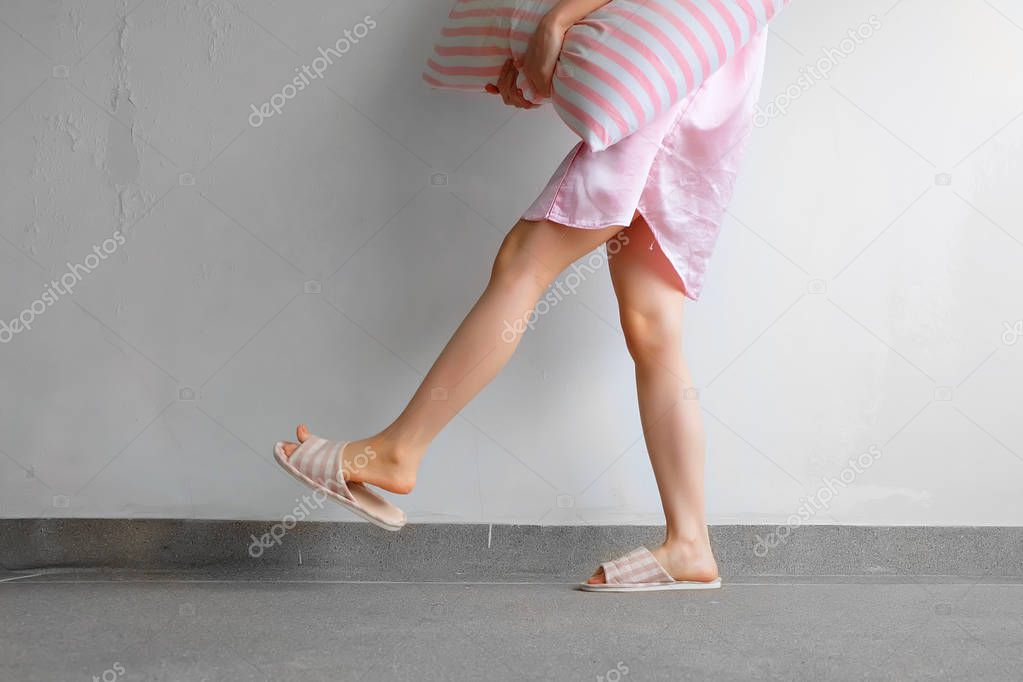 Girl Standing in Sleepwear and Pink Checkered Slippers with Holding Pink Pillow on Floor