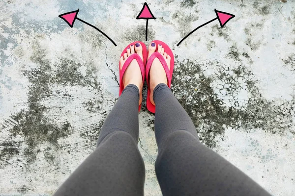 Violet Nail Pedicure. Womans Sandals Feet with Arrows Drawn Choices Direction on Cement Background