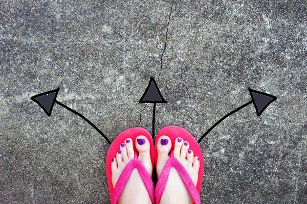 Violet Nail Pedicure. Womans Sandals Feet with Arrows Drawn Choices Direction on Cement Background