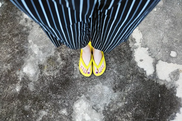 Sarı sandal. Selfie Womans sandalet ayak Violet ile çimento arka plan üzerinde boya pedikür tırnak