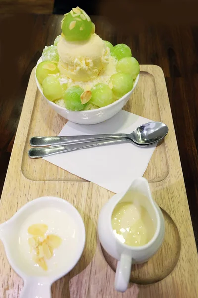 Melon Bingsu Korean Shaved Ice Dessert on Tray with Topping and Milk on Wooden Table Background — Stock Photo, Image