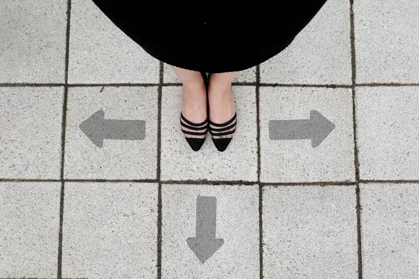 Directional Arrow and Pair of Black Shoes Woman Standing on The Tile Background Great for Any Use.