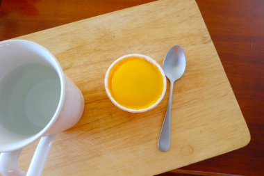 Kaşık ahşap ve ahşap masa arka camına ile taze turuncu kek