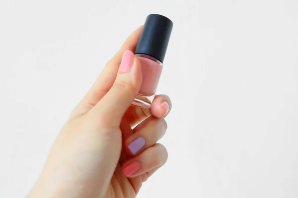 ピンク塗られた爪の手を閉じます 女性のピンクのボトルと美しいピンクの爪のマニキュアが白背景偉大な任意の使用するために手 — ストック写真