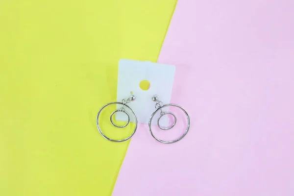 Silver Earring Accessories Drop Earrings Isolated Yellow Pink Pastel Background — Stock Photo, Image