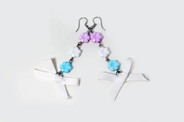 吊灯耳环 美丽的丝带弓耳环时尚配件的顶级视图 一对耳环与粉彩花珠隔离白色背景伟大的任何使用 — 图库照片