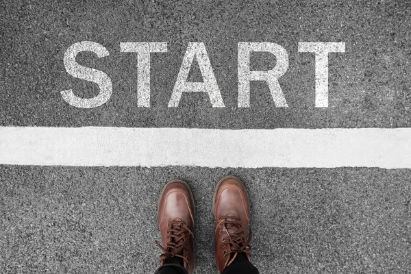 Start background, top view. Selfie of feet and legs in leather ankle boots on pathway. Hipster woman in brown shoes on starting line new beginning idea. Business challenge concept. Moving forward.