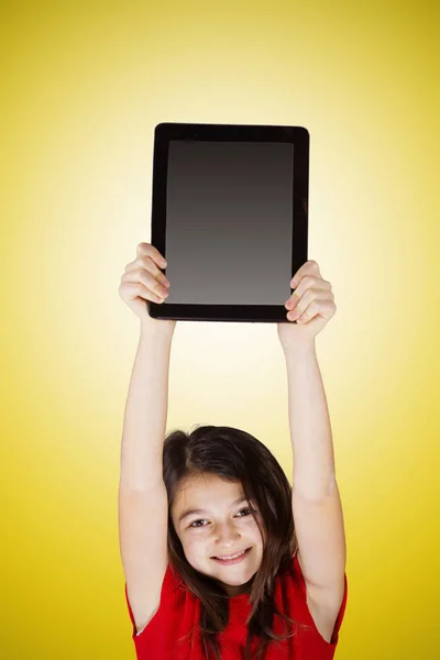 Feliz sonrisa niña sosteniendo la tableta — Foto de Stock