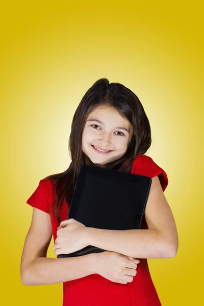 Happy smiling little girl holding tablet — Stock Photo, Image