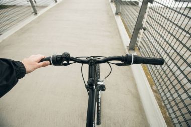 Yakın çekim yansıma bir bisikletçi adam parkta Bisiklete binmek gidon üzerinde eller, yüz görünür değil