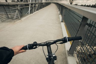 Yakın çekim yansıma bir bisikletçi adam parkta Bisiklete binmek gidon üzerinde eller, yüz görünür değil.