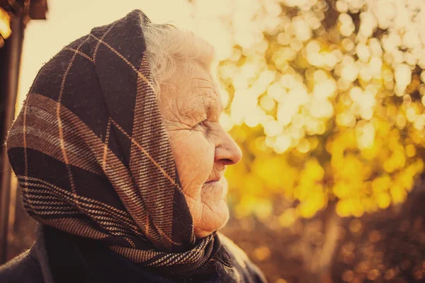 Elderly woman enjoying sunset