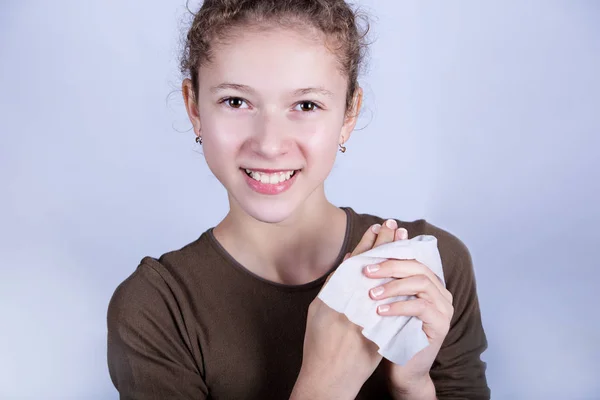 Child Hygiene.Little girl cleaning her hands with a wet baby wipe isolated on a white background. — Stock Photo, Image