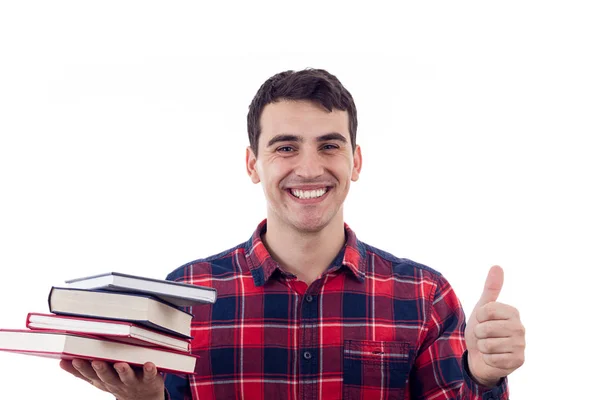 Étudiant souriant jeune homme avec le pouce levé tenant des livres sur sa main — Photo