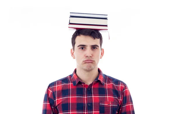 Estudante perturbado com pilha de livros na cabeça — Fotografia de Stock