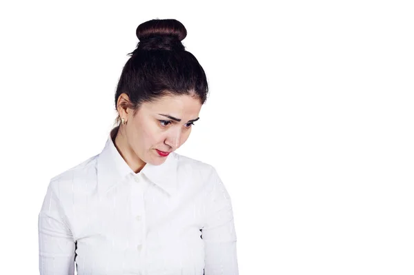 Woman looking down thinking beeing dissatisfied over white background — Stock Photo, Image