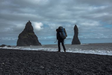 Siyah kum plaj, Vik İzlanda üzerinde yürüyen sırt çantası ile turizm