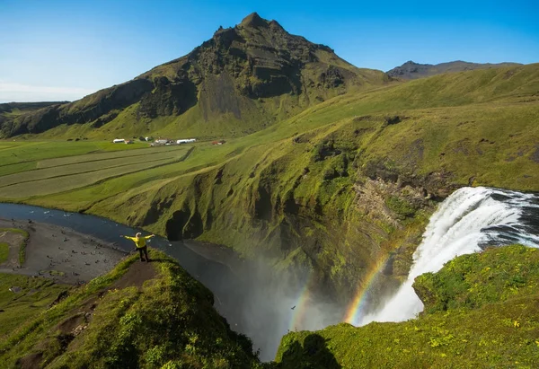 站在美丽和著名斯科加瀑布瀑布附近的旅游。冰岛南部的 — 图库照片