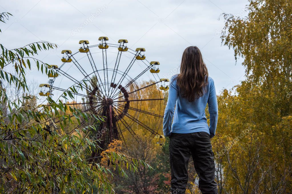 Girl standing in Pripyat Chernobyl Zone, autumn time Chernobyl, Ukraine
