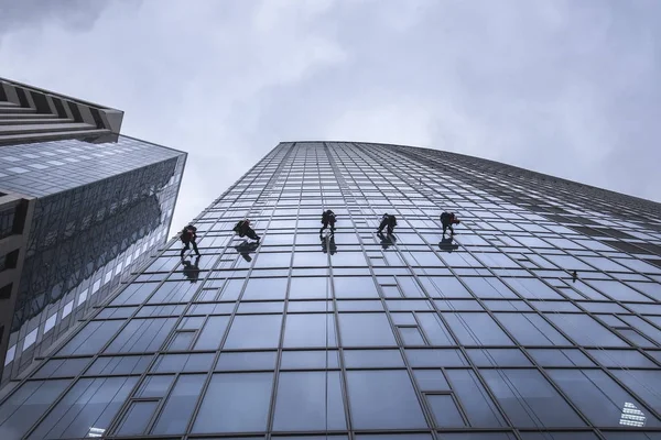 Παράθυρο πλυντήρια καθαρισμού τη γυάλινη πρόσοψη ενός ουρανοξύστη — Φωτογραφία Αρχείου