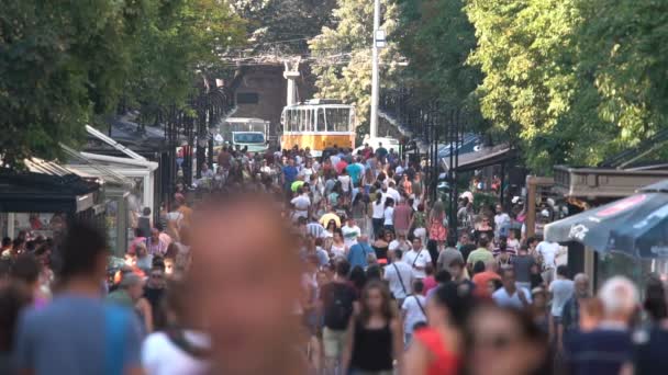 Crowded street with people and a tram car — Stock Video