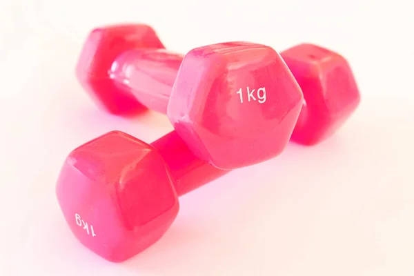 1 KG pink dumbbells on white background Stock Image