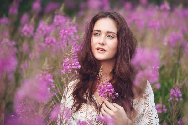 Young woman in pink flowers — Stock Photo, Image