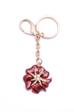gold keyring with a flower isolated on white clipart