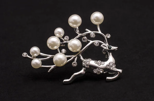 Silver brooch deer with pearls isolated on black — Stock Photo, Image