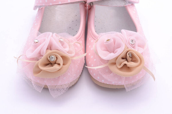 Baby pink shoes isolated on white

