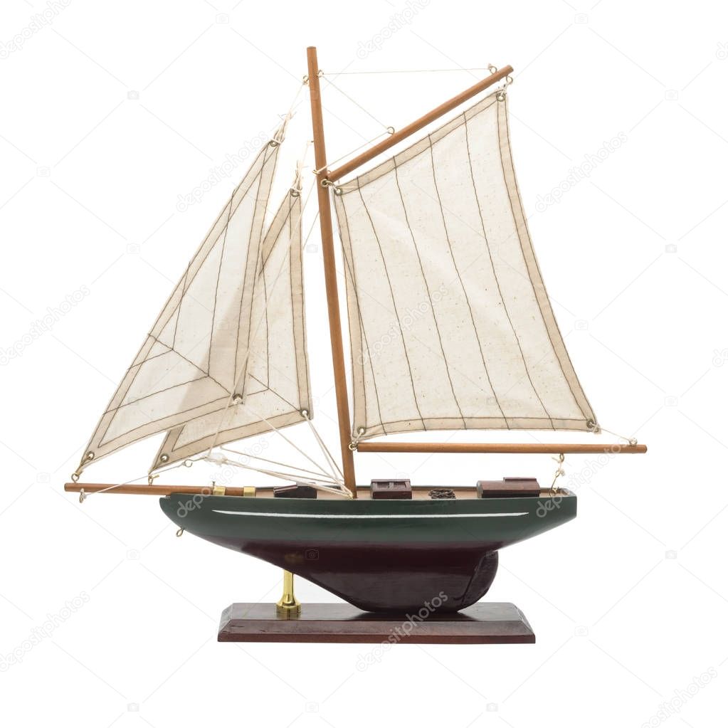 model wooden yacht with sails isolated on white