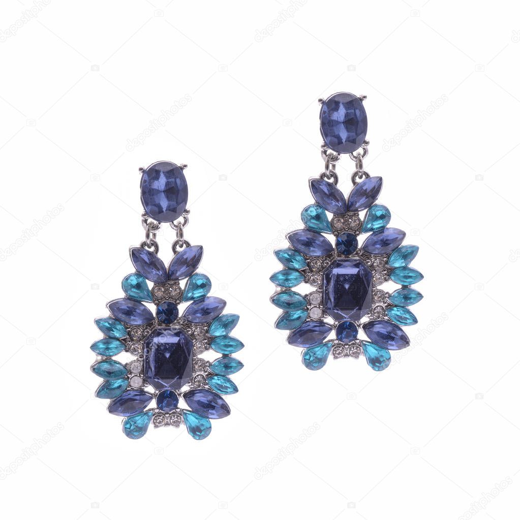 Earrings with blue stones isolated on white