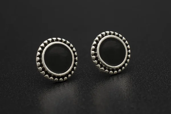 silver stud earrings isolated on black