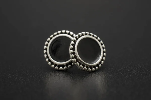 silver stud earrings isolated on black