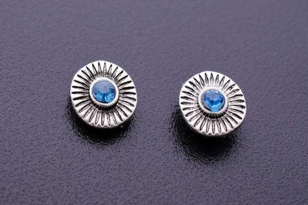 Silver stud earrings with blue stone isolated on black — Stock Photo, Image