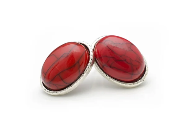 silver stud earrings with red stones isolated on white