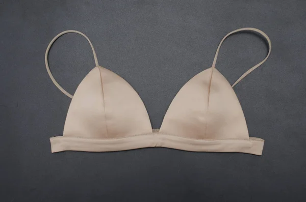 Triangular beige silk bra isolated on black, bralette — Stock Photo, Image