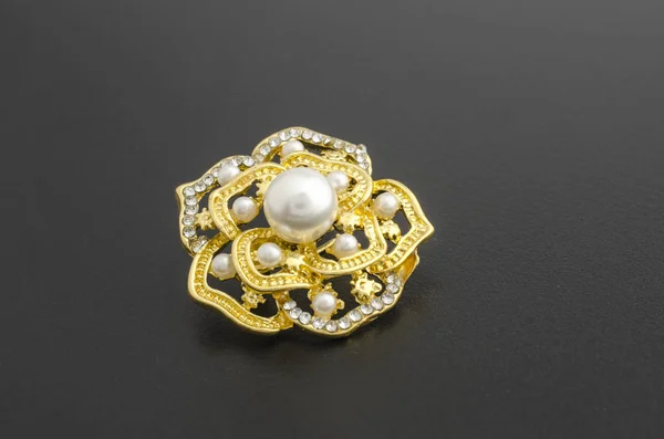 Gold brooch flower with pearl isolated on black — Stock Photo, Image