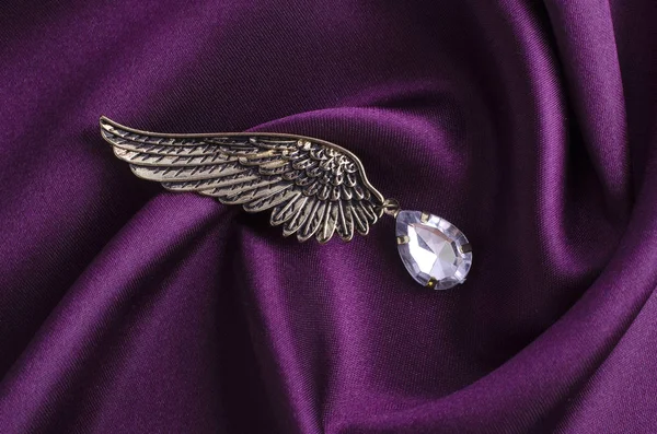 Brooch wing with diamond on silk — Stock Photo, Image