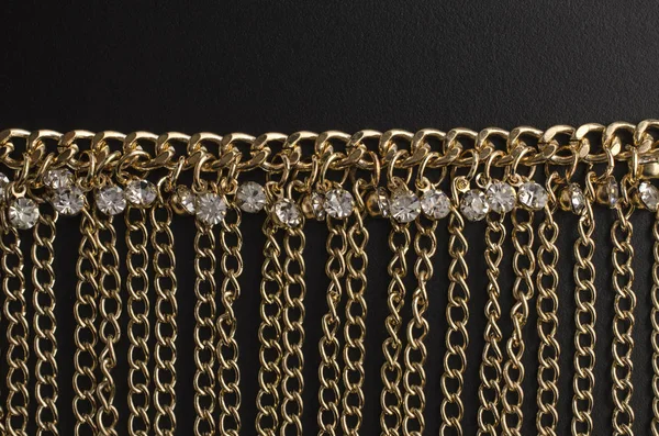 Gold necklace with chains and diamonds isolated on black — Stock Photo, Image