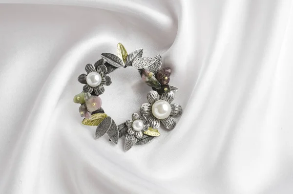 Broche redondo com flores e pérolas em seda branca — Fotografia de Stock