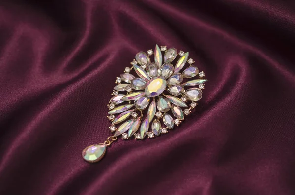 Brooch with colored crystals on silk fabric — Stock Photo, Image