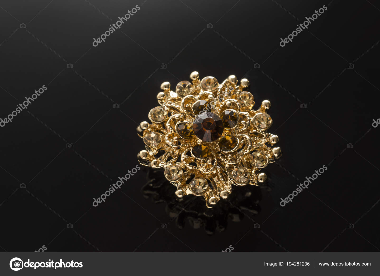 gold round brooch