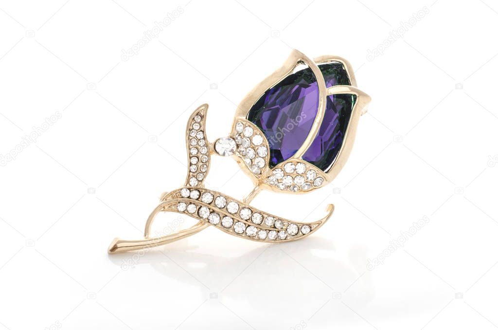 gold brooch rose bud with purple stone and diamonds isolated on white