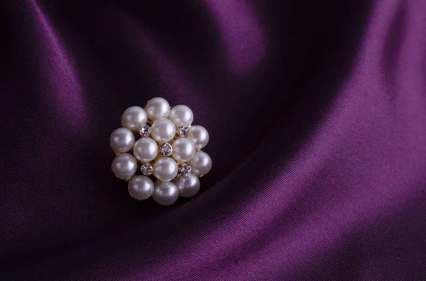 Round brooch with pearl on silk — Stock Photo, Image