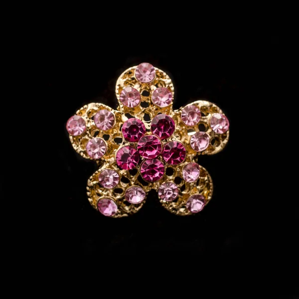 Broche flor de oro con diamantes rosados aislados en negro —  Fotos de Stock