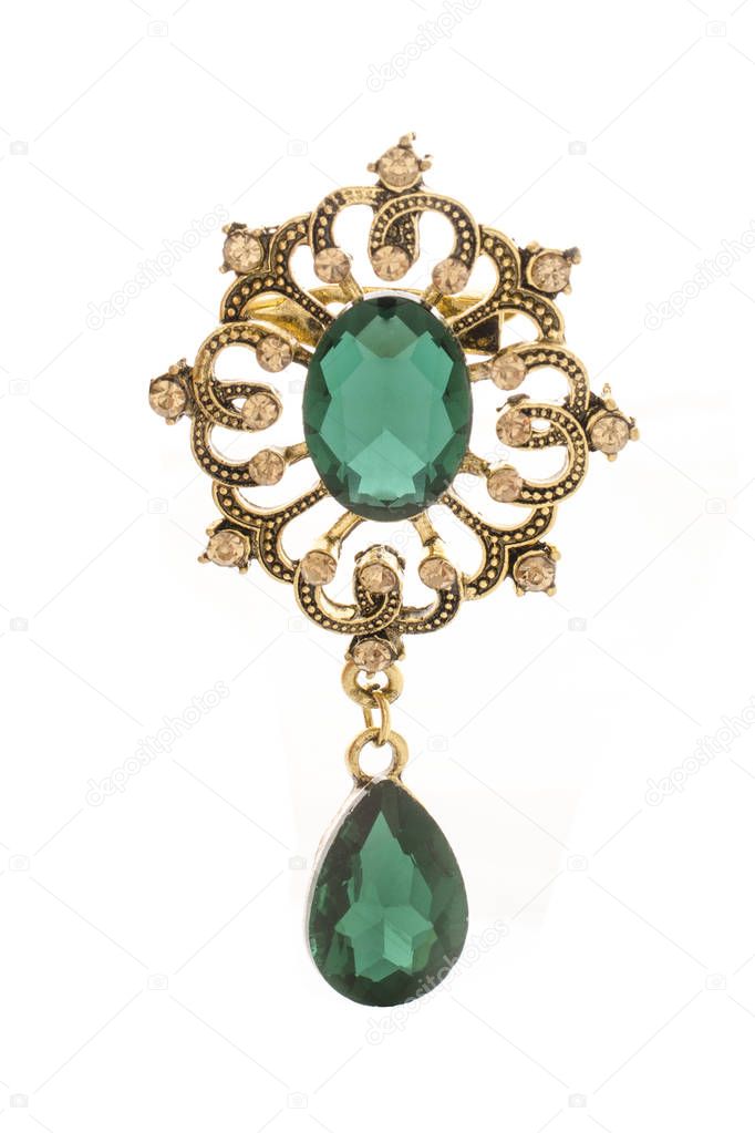 golden vintage brooch with emeralds isolated on white